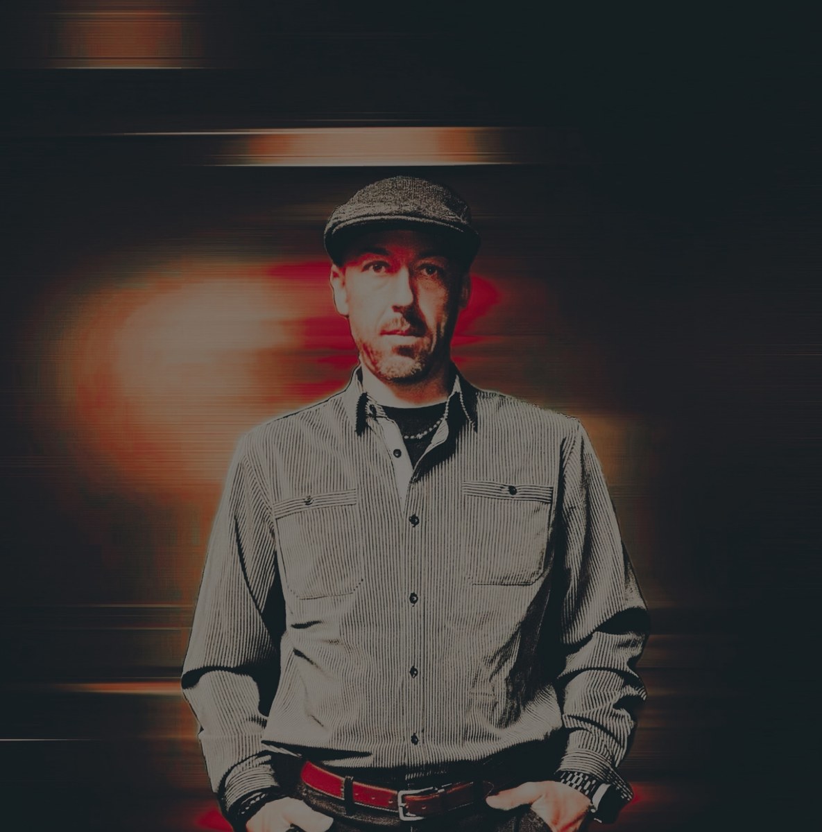 Studio portrait of Jamie Mahn in his signature flat cap.